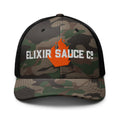 Elixir Sauce Co camouflage trucker hat in Camo and Black, front view